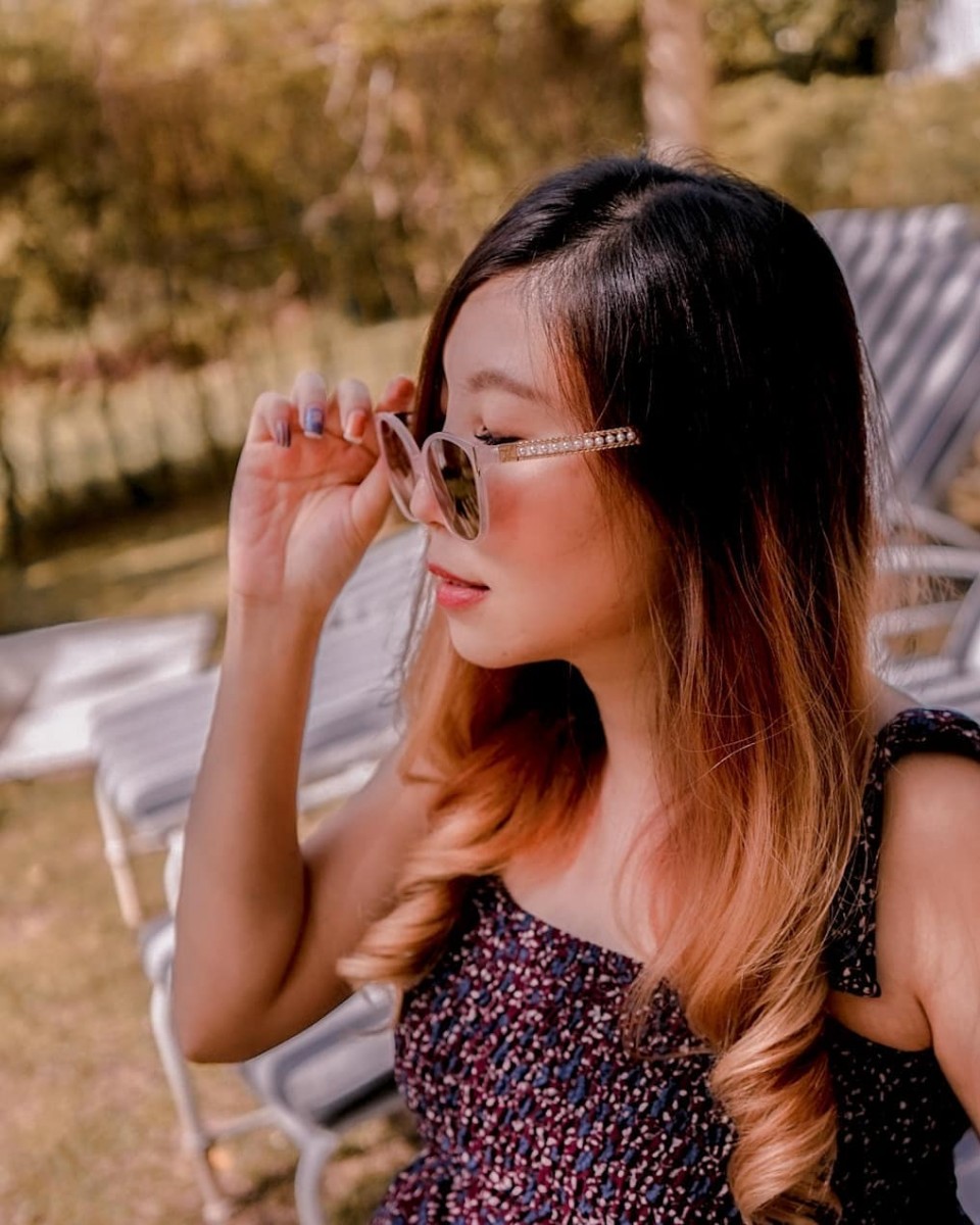 Model wearing pink sunglasses with pearls