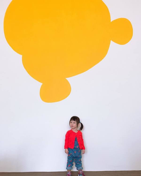 minimalist white and yellow wall in Winnie-The-Pooh-Themed YUME coffee shop