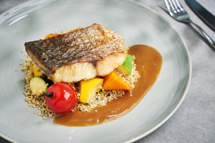 baked fish on assorted vegetables