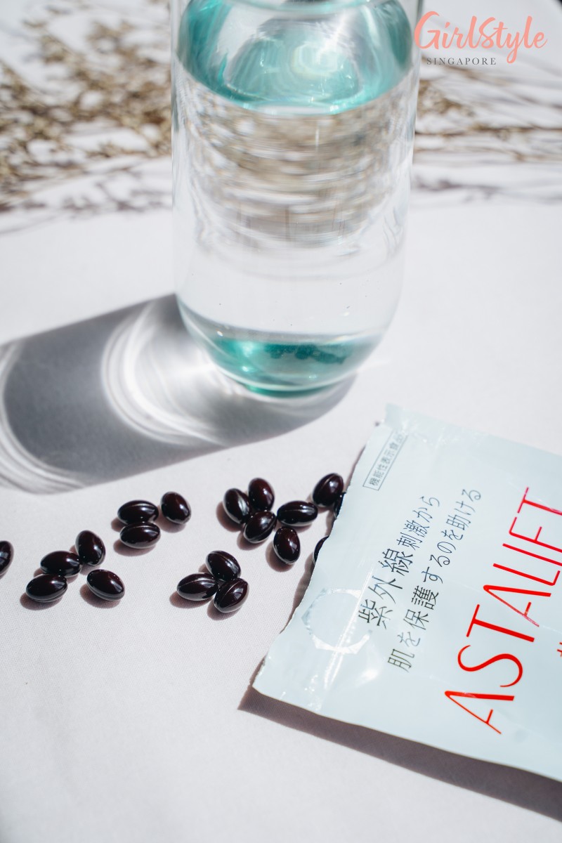 glass of water and ASTALIFT White Shield 30-Day Pack Supplement tablets