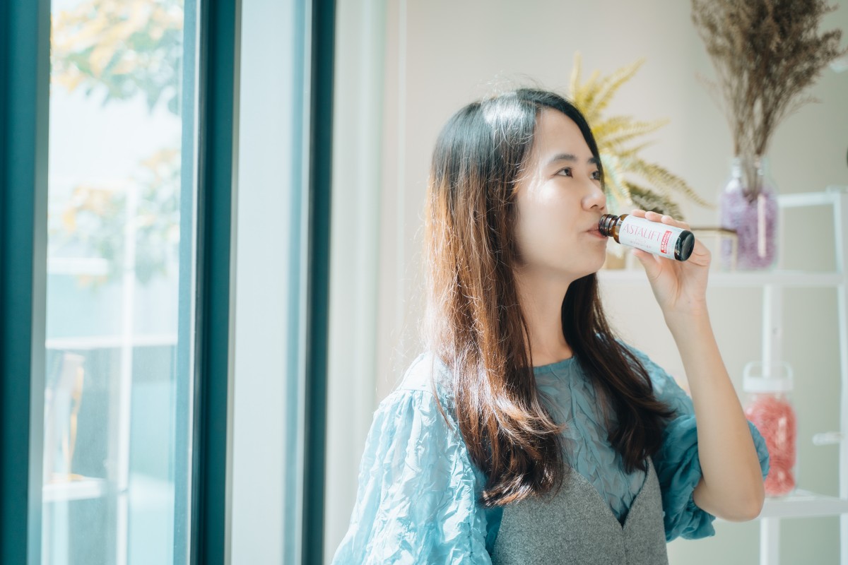 asian woman drinking ASTALIFT Drink White Shield