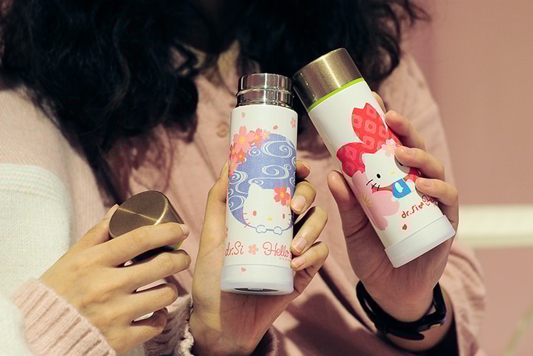 woman holding dr.Si x Hello Kitty Cherry Blossom Viewing mini Pocket water Bottle