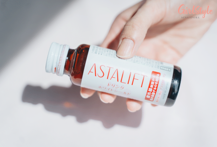 hand shaking ASTALIFT Drink White Shield bottle