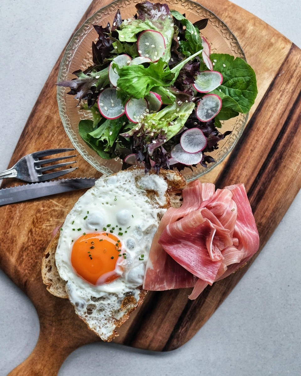 salad, sunny side up egg and cured pork