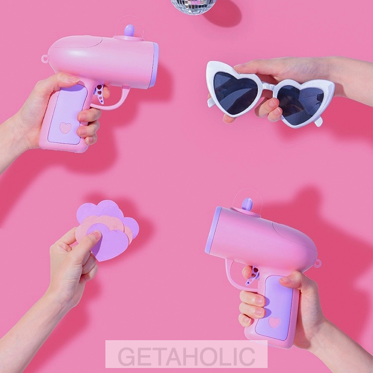 pastel pink gun shooting heart-shaped cards