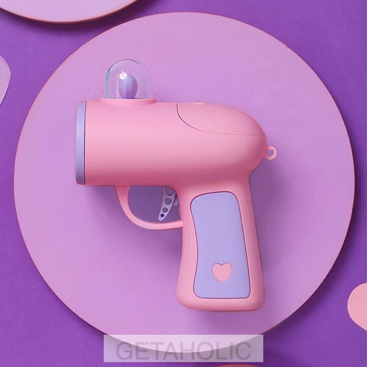 pastel pink gun shooting heart-shaped cards