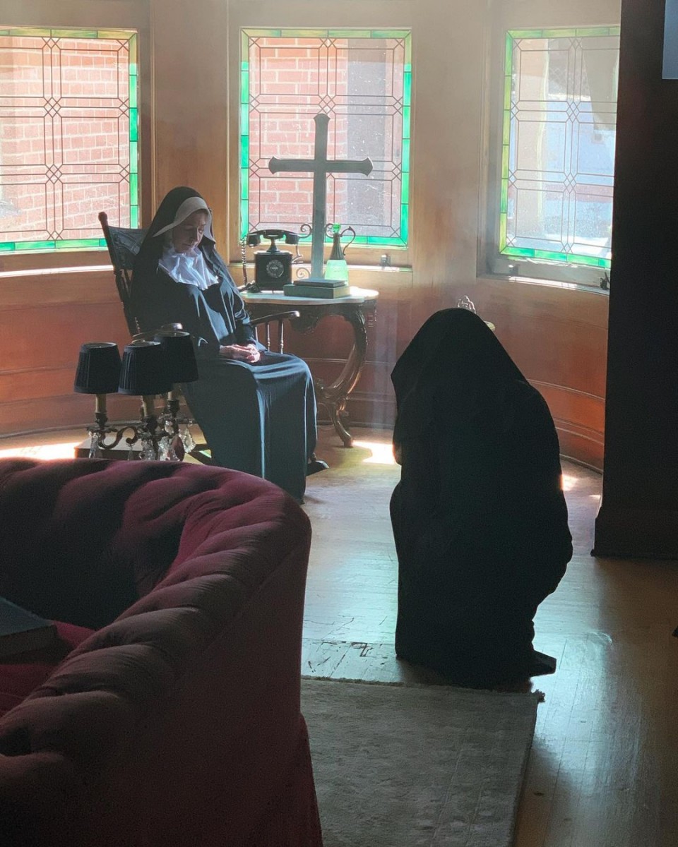 nun sitting on chair in Rosenheim Mansion
