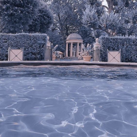 blue aesthetic pool and hedges