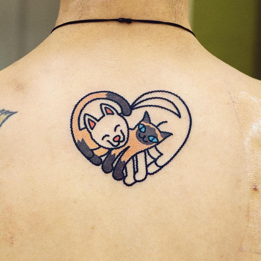 cartoon style tattoo two cats as a heart