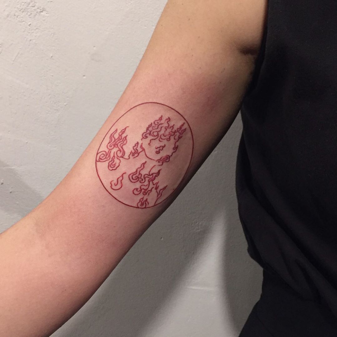 neo traditional style red fire circle tattoo in arm