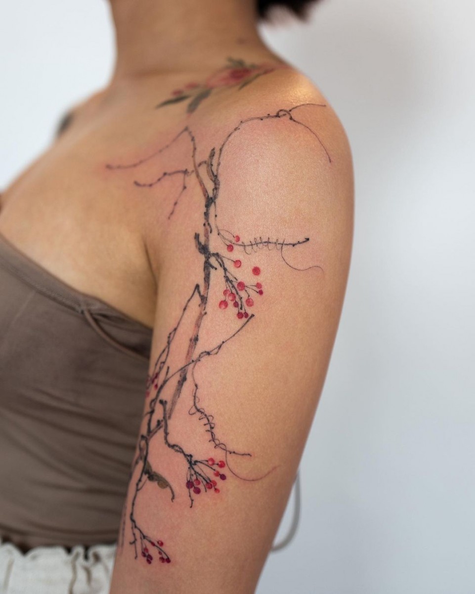 oriental style tattoos on arm and collarbone