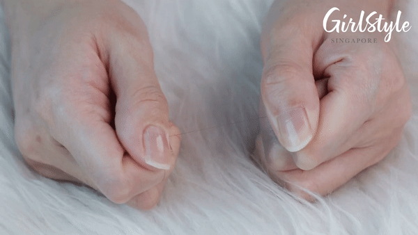 pulling a strand of hair that snaps