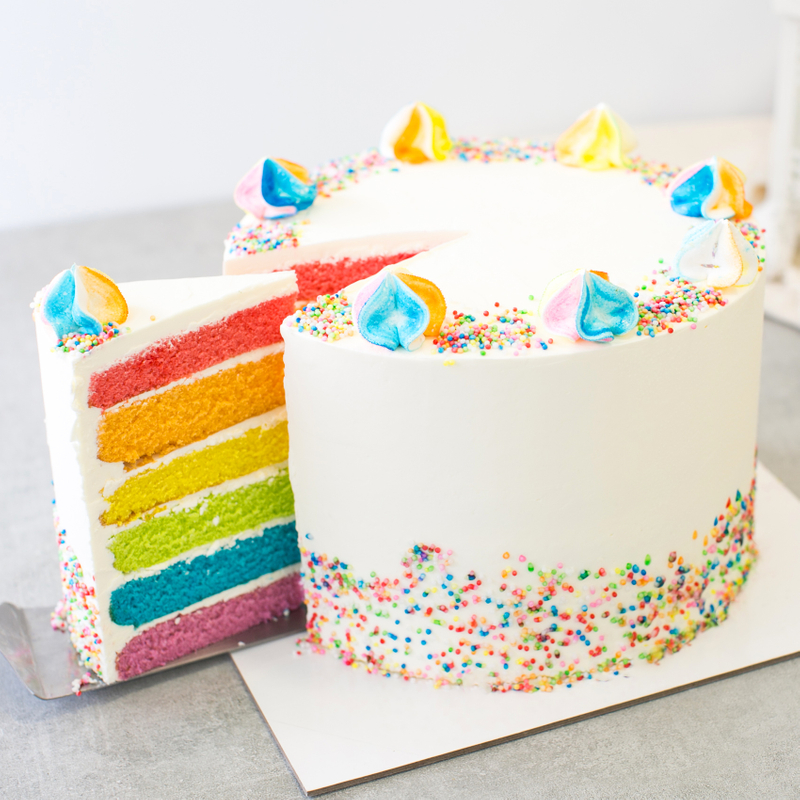 rainbow cake with sprinkles and meringue cookies