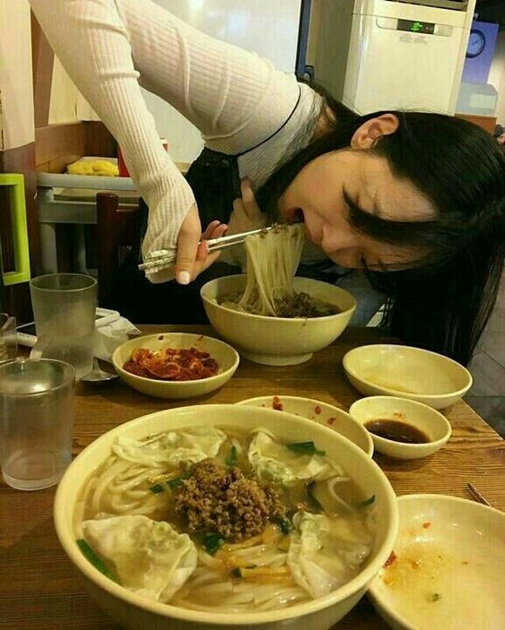 asian girl eating noodles