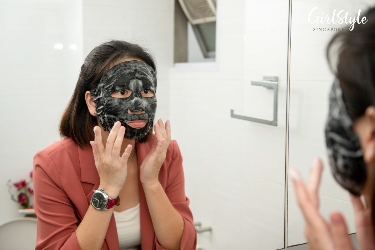 woman trying on ellure tomato face mask