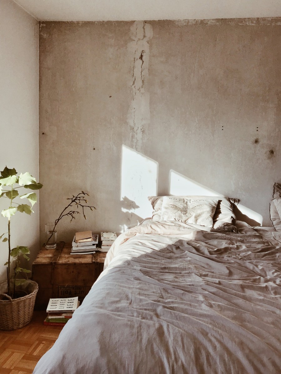 Minimalist bedroom with beige bed sheets