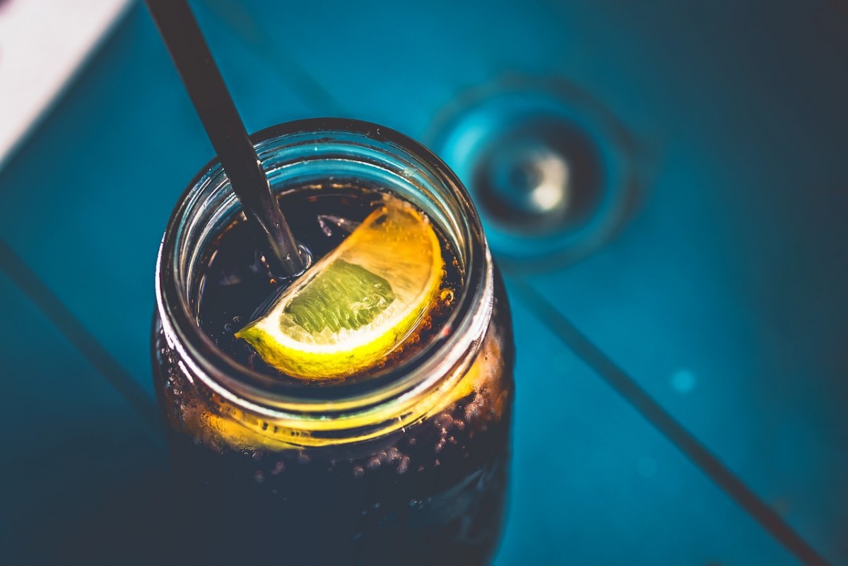 soda in a glass bottle with a slice of lemon