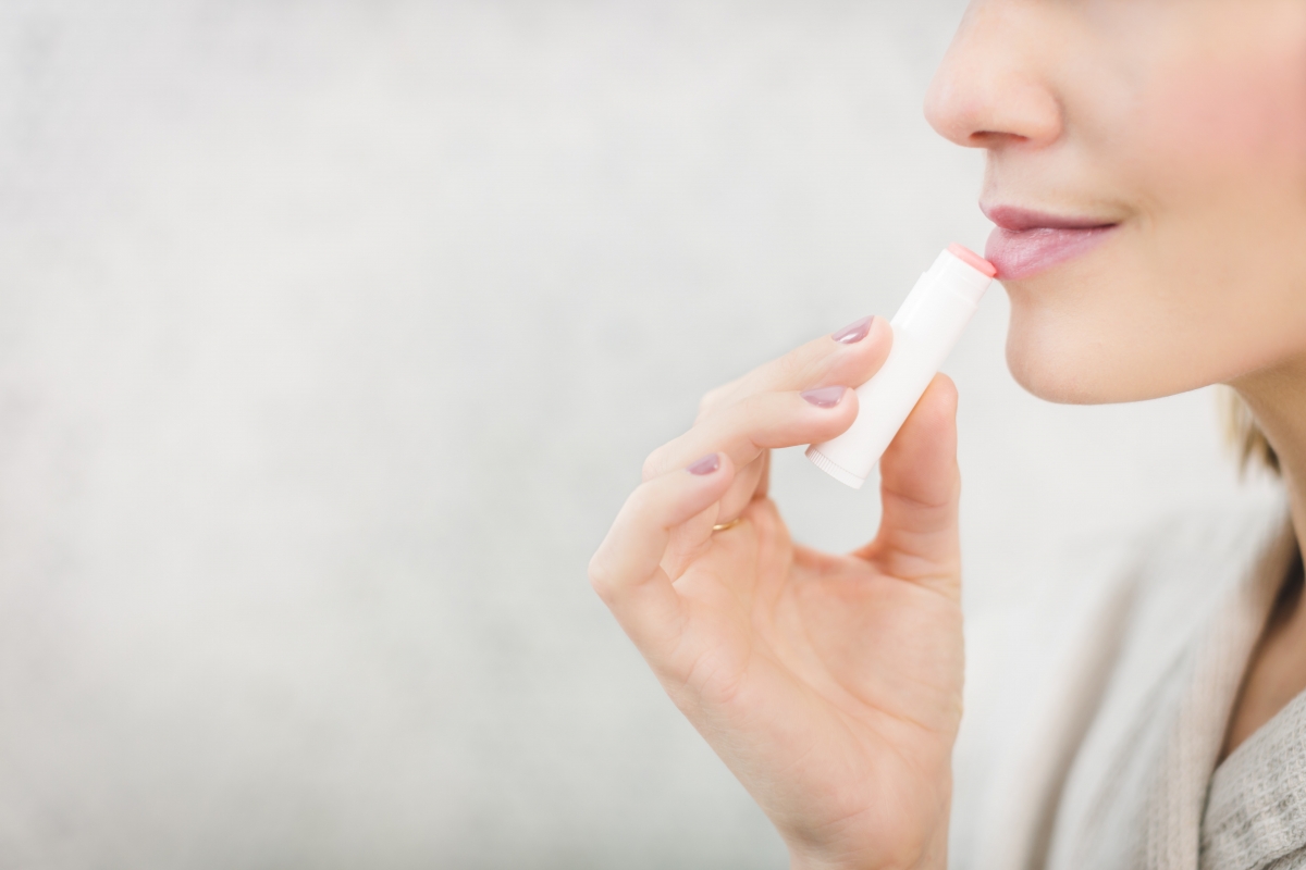 Girl applying lip balm