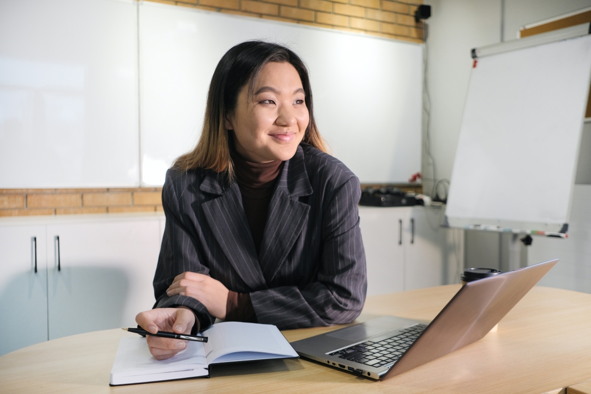 asian woman in office holding a pen