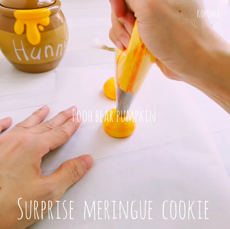 piping orange and red pumpkin meringues