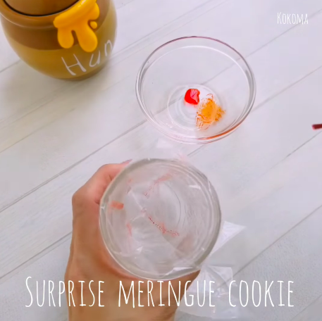 painting red and orange food colouring on plastic wrap