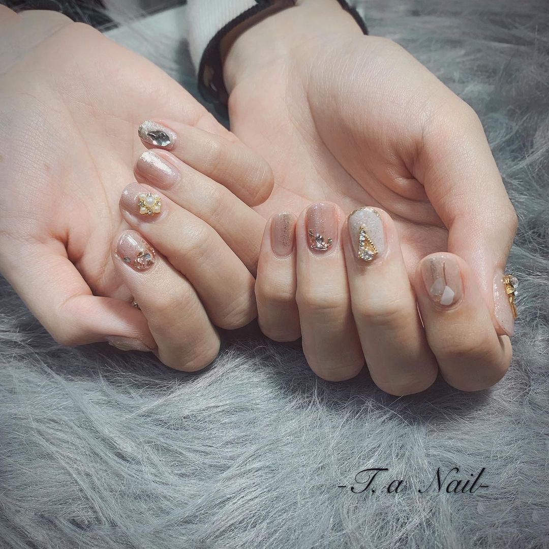 milk tea nail art with pearl and jewel embellishments