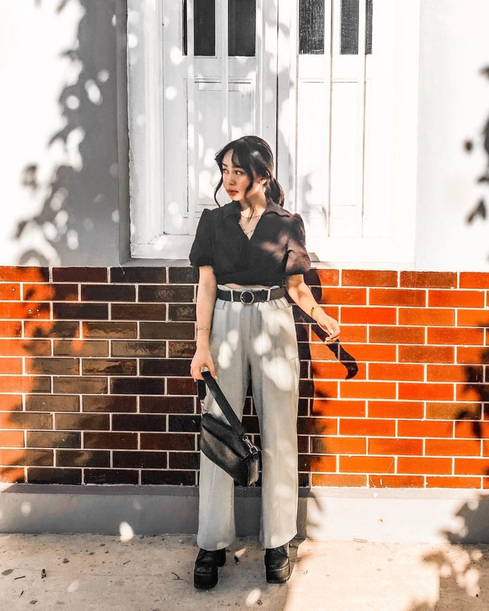 asian girl wearing black crop top and belted cream high waisted trousers