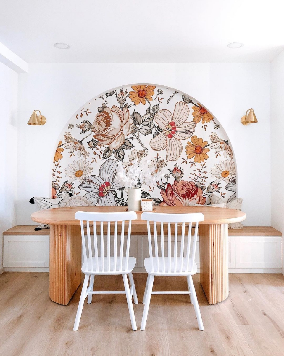breakfast dining nook in singapore with floral arch and wood table