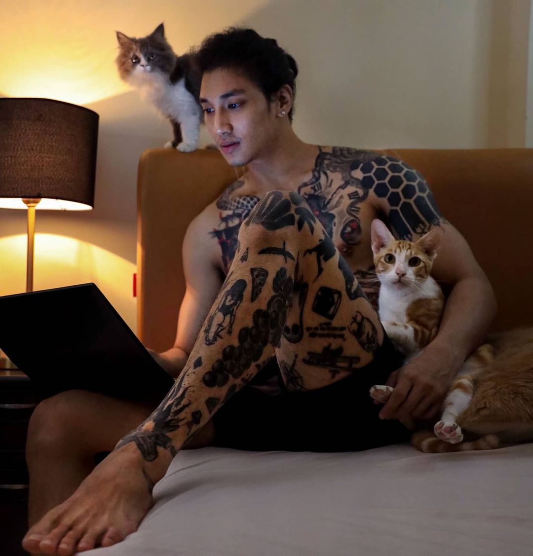 shirtless paing takhon with cat and dog