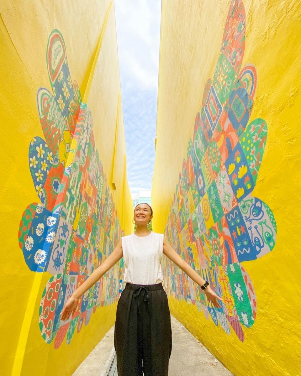 yellow wall with wings at medley alley at katong