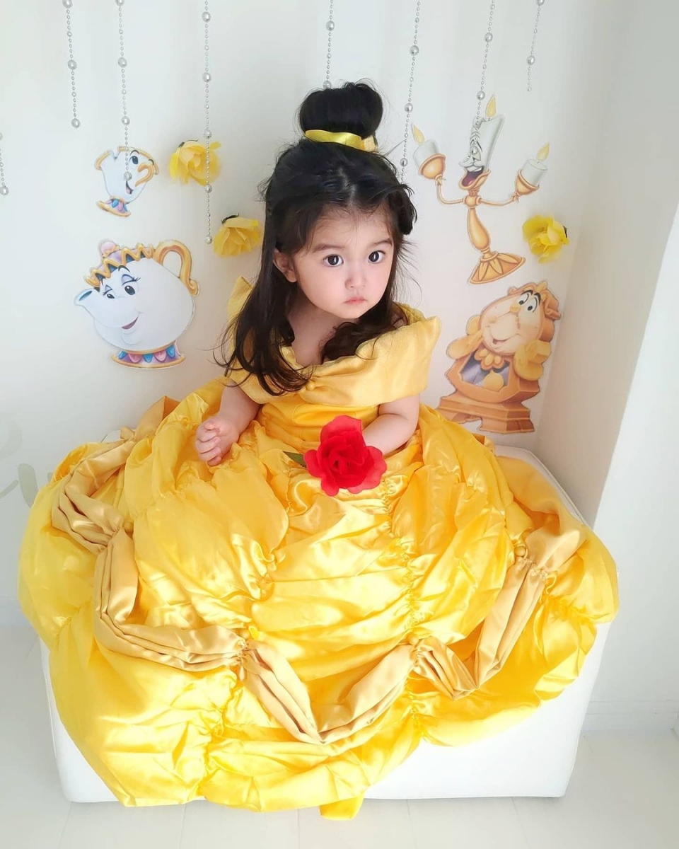 asian baby dressed as princess belle with yellow dress