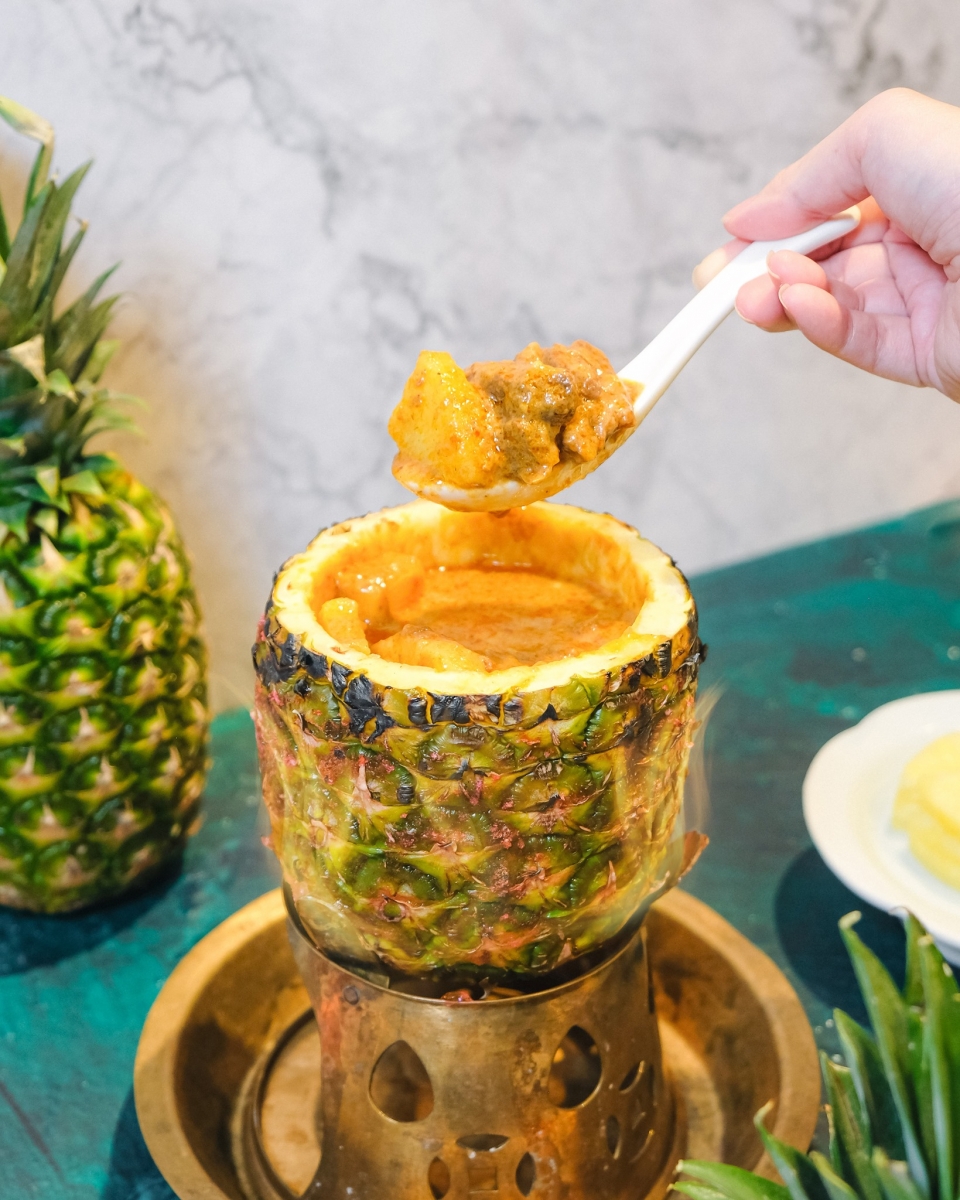 curry beef brisket in pineapple on fire
