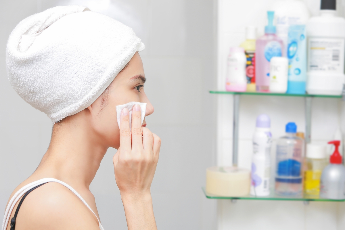 Lady applying toner using cotton pad