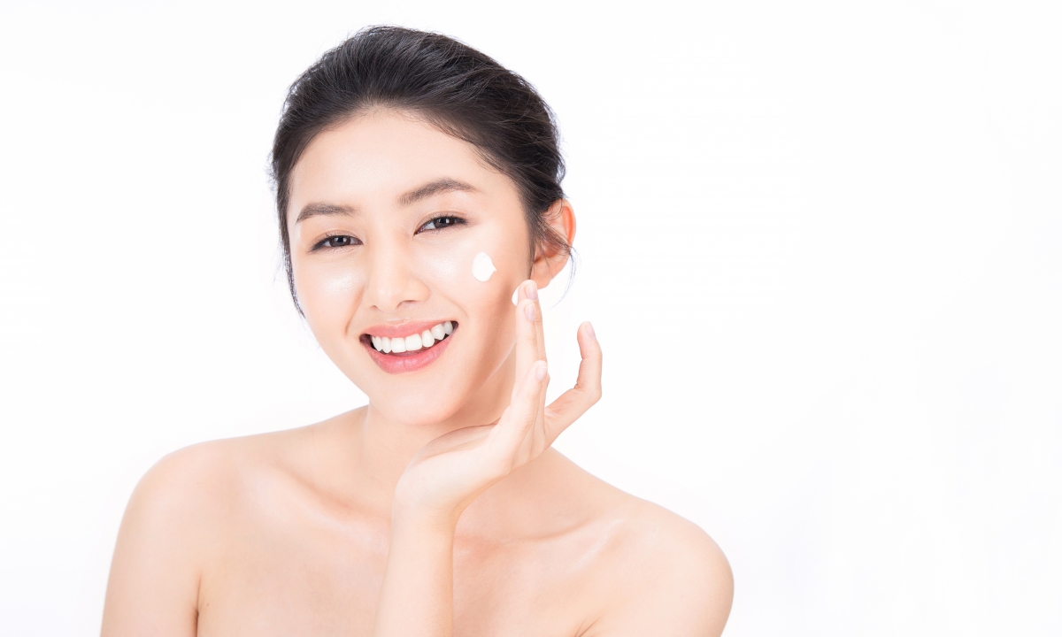 Lady applying skincare products on skin