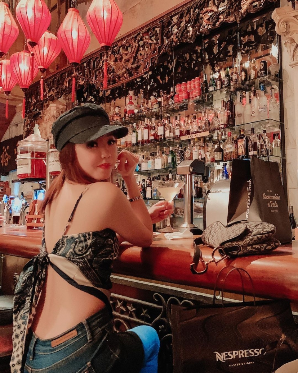 Girl sitting at the bar of No. 5 Emerald Hill