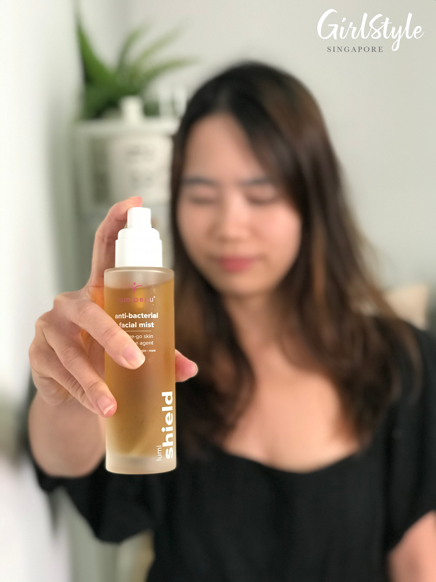 woman spraying on lumipeau anti bacterial facial mist