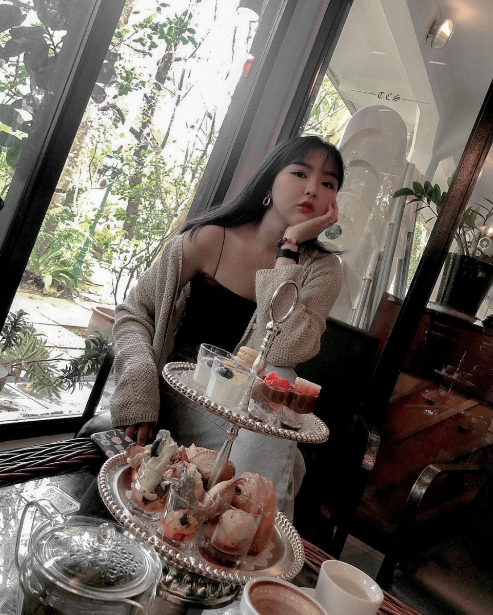 Posing with high tea set at The Coastal Settlement