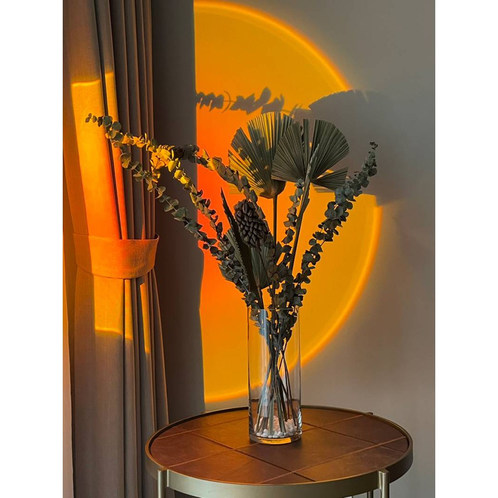 Sunset projection lamp shining on table and wall