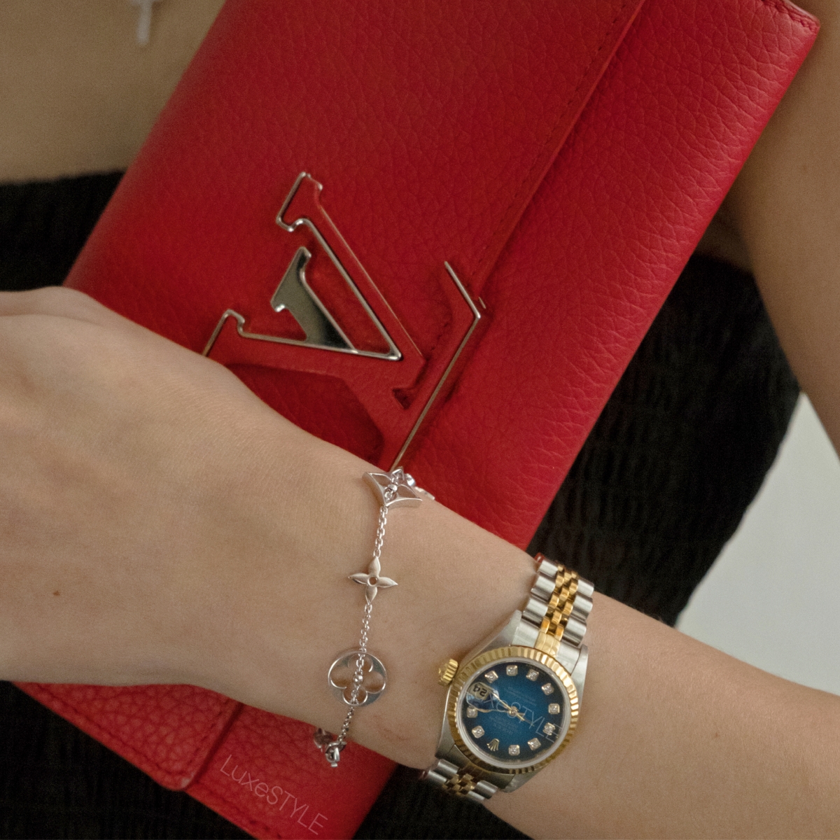 branded bracelet, watch and red louis vuitton clutch bag