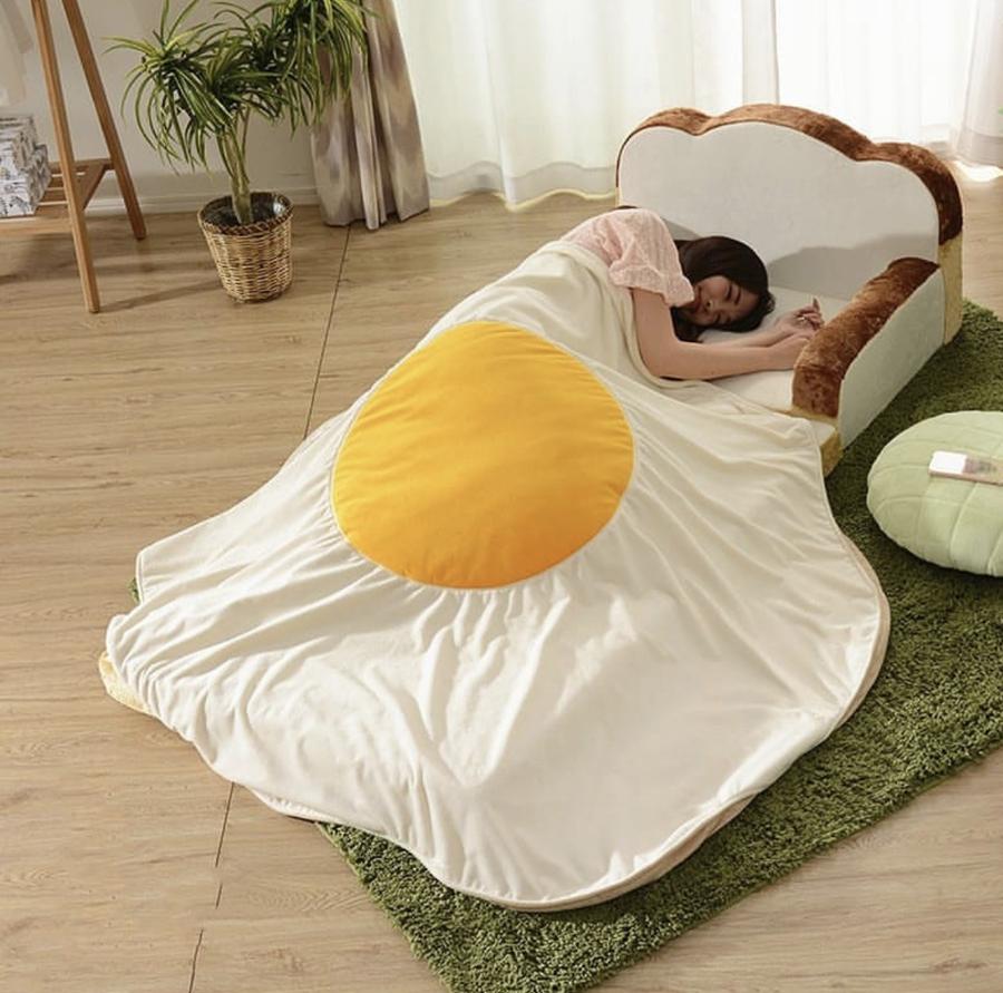 woman sleeping on egg blanket and toast chair