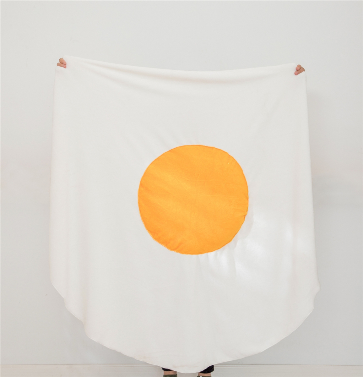 person holding up egg blanket