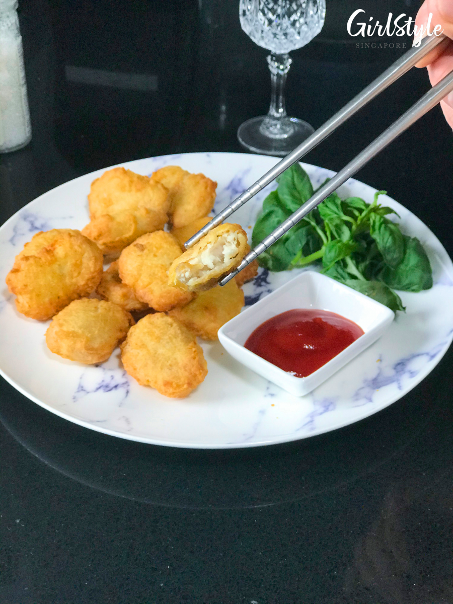 plate of gourmet nuggets with greens and ketchup
