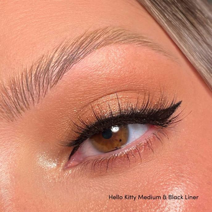 woman wearing magnetic false eyelashes hello kitty glamnetic