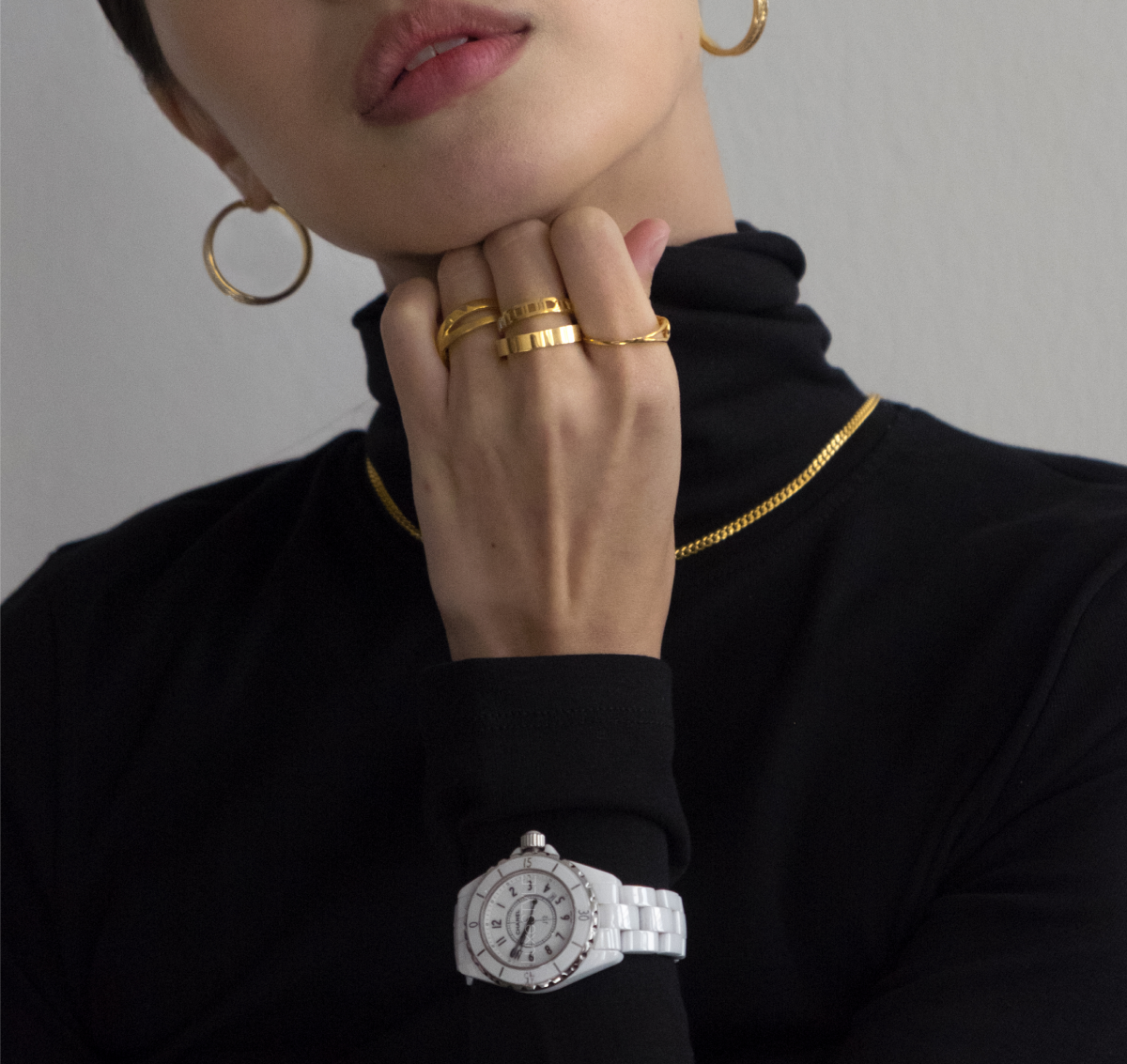 woman wearing real gold jewellery and white watch