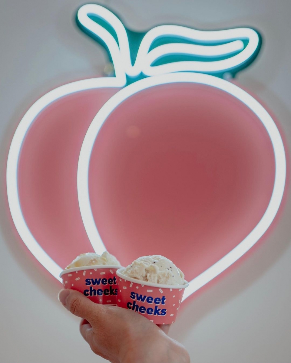 Close up of peach neon light at Sweet Cheeks