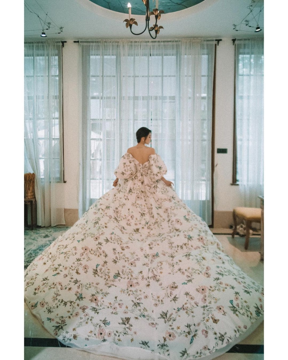 Monique Lhuiller floral gown with puffed sleeves and long train