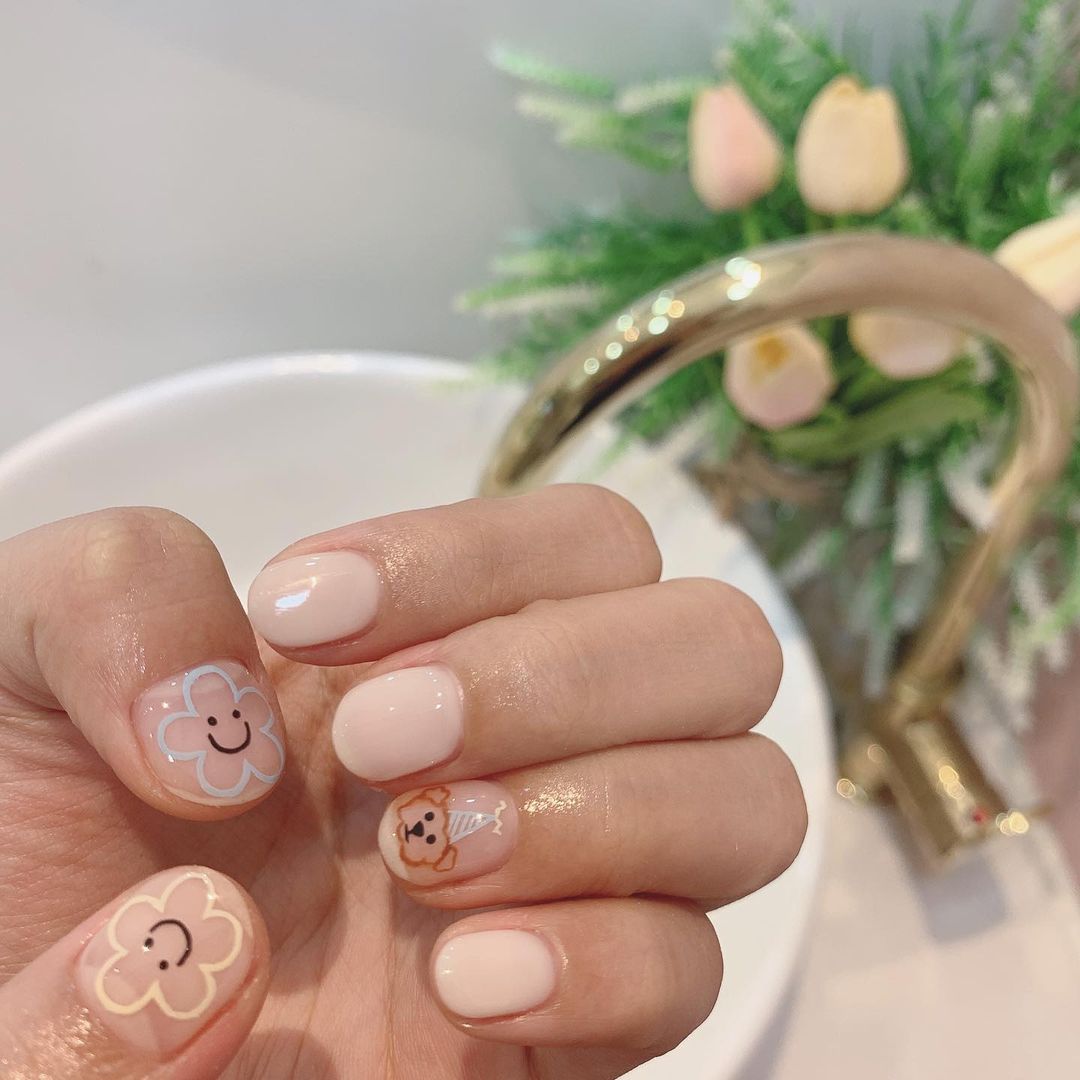 nude nail art with pastel flowers and poodle