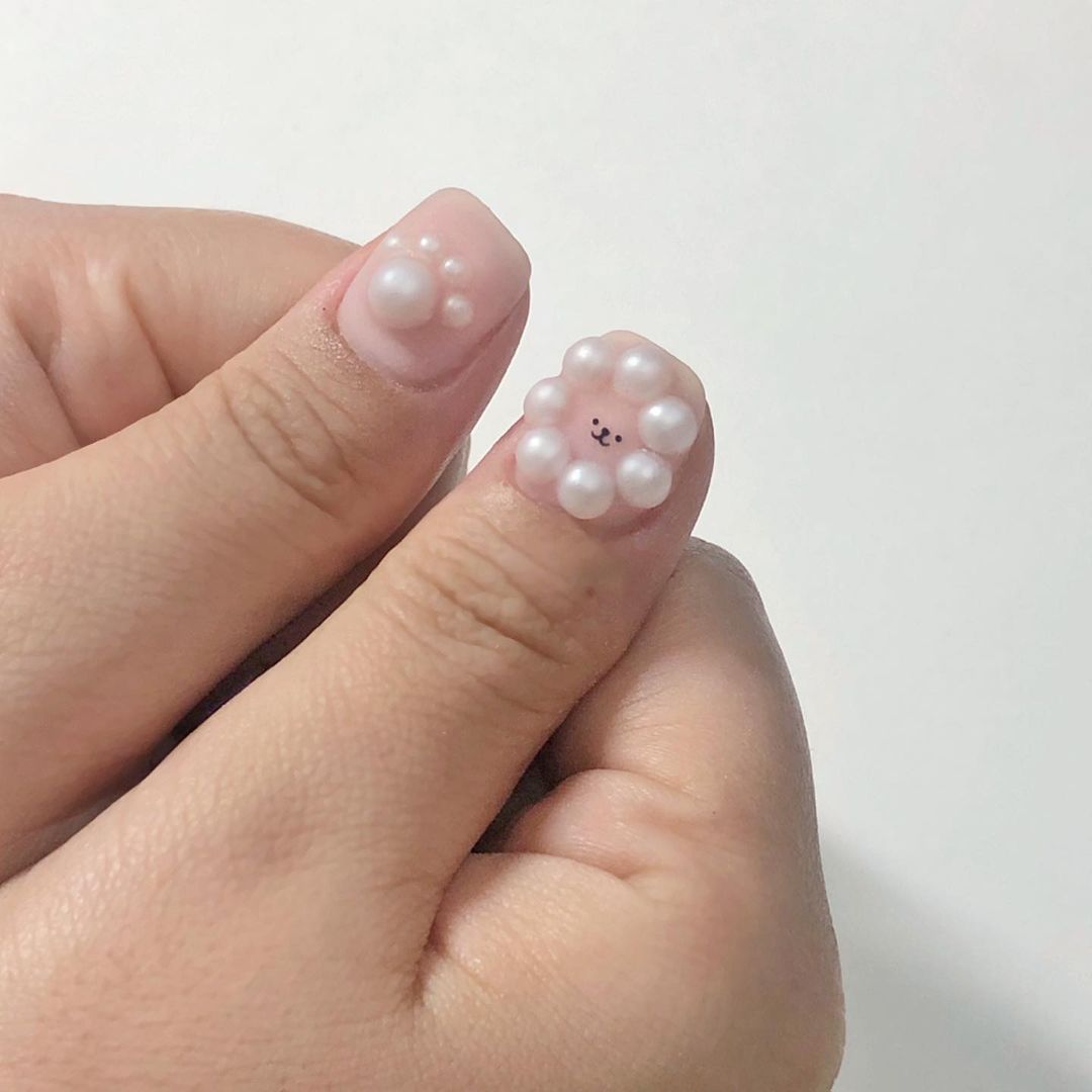 pearl poodle nail art on thumbs