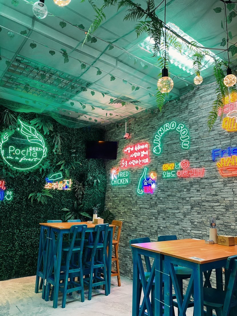 Pocha in a Forest neon lights and seating