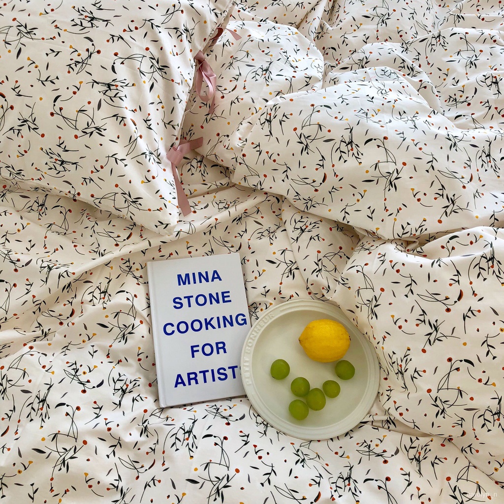 white floral korean style bed with book and plate of fruit
